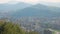 Aerial view of Bilbao city lying in valley, green mountains at back, Spain