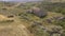 Aerial view, bird eye of the ancient ruin church in the middle of fields with hay bales