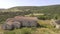 Aerial view, bird eye of the ancient ruin church in the middle of fields with hay bales