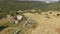 Aerial view, bird eye of the ancient ruin church in the middle of fields with hay bales