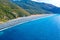 Aerial view of the black pebble beach, Nonza, Mediterranean scrub, hillsides close to the coast. Cap Corse Peninsula, Corsica. Coa