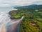 Aerial view of black sand beach with river, ocean and waves in Bali