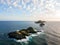 Aerial view of the Bloods Islands and Lighthouse, Corsica, France: rocks, waves and sailboat