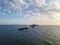 Aerial view of the Bloods Islands and Lighthouse, Corsica, France: rocks, waves and sailboat