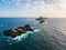 Aerial view of the Bloods Islands and Lighthouse, Corsica, France: rocks, waves and sailboat