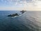 Aerial view of the Bloods Islands and Lighthouse, Corsica, France: rocks, waves and sailboat