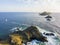 Aerial view of the Bloods Islands and Lighthouse, Corsica, France: rocks, waves and sailboat