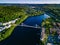 Aerial view of blue lake with cable-stayed bridge and green summer town in Finland