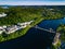 Aerial view of blue lake with cable-stayed bridge and green summer town in Finland