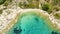 Aerial view of a blue ocean near a cliffy shore at daytime