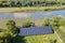 Aerial view of blue photovoltaic solar panels mounted on backyard ground for producing clean ecological electricity. Production of