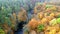 Aerial view of blue river and yellow autumn forest