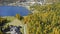 Aerial view of blue Sankt Moritz lake, village and autumn forest in Switzerland