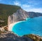 Aerial view of blue sea, rock, sandy beach at sunset in summer