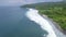 Aerial view blue sea waves and green tropical island landscape. Drone view blue ocean waves and rice paddy fields. Bali