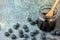 Aerial view blueberries, blueberry jam in glass jar with wooden spoon, on blue background, horizontal,