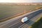 Aerial view of blurred fast moving cargo van driving on highway hauling goods. Delivery transportation and logistics