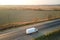 Aerial view of blurred fast moving cargo van driving on highway hauling goods. Delivery transportation and logistics