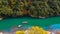 Aerial view boat on the river bring tourist people to enjoy autumn colors along katsura river to Arashiyama mountain area during