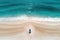 Aerial view of a boat on the sandy beach in the ocean, The man sitting on the beach with Jetski in Perth, Western Australia. Top