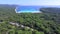 Aerial view of boats in a beautiful azure lagoon with highway in the foreground