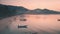 Aerial view boats near seashore around mountains and trees. Evening calm ocean beautiful landscape.