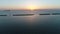 Aerial view of breakwater of stone at sunset