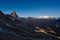 Aerial view of Breuil Cervinia village glowing in the night, famous ski resort in Aosta Valley, Italy. Wonderful starry sky over M