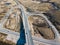 Aerial view of bridge and highway with intersection and roundabout  on a sunny spring day, Kuldiga, Latvia