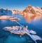 Aerial view of bridge over the sea and snowy mountains in Norway