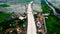 Aerial view. Bridge under construction and the edge of an urban river with houses