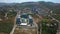 Aerial view of the budget hotel with the outdoors swimming pool. Clip. Southern green city with many trees.