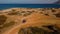 Aerial view of buggy car on the sandy on the sea coast of Cyprus or Greek in summer. Extreme trip off road place. Outdoor adventur