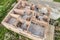 Aerial view of building site for future house, brick basement floor and stacks of brick for construction