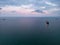 aerial view of a bulk carrier at evening showcases a stunning display of lights reflecting off the water as the massive