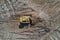 Aerial view of a bulldozer moving waste on a landfill site