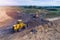 Aerial view on bulldozers working on the landfill.