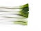 Aerial view of a bunch of leeks on a white table