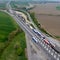 Aerial view of a bustling highway featuring numerous cars traveling on each side of the roadway