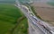 Aerial view of a bustling highway featuring numerous cars traveling on each side of the roadway