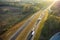 Aerial view of busy american freeway with fast moving cars and trucks. Interstate hauling of goods concept