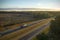 Aerial view of busy american freeway with fast moving cars and trucks. Interstate hauling of goods concept