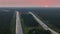 Aerial view of busy American highway with fast moving traffic at sunset. Interstate transportation concept