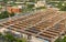 Aerial view of busy industrial under construction site workers working with cranes and excavators. Top view of precast concrete