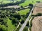 an aerial view of a busy road running through beautiful rolling countryside