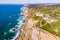 Aerial view of Cabo da Roca lighthouse with majestic coastline looking the Atlantic Ocean, a famous landmark in Colares, Lisbon,