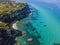 Aerial view of the Calabrian coast, cliffs overlooking the crystal clear sea and luxury villas. Riaci, Tropea, Italy