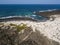 Aerial view of the Caleta del MojÃ³n Blanco, sandy desert beach and rugged coastline. Lanzarote, Spain. Africa