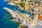 Aerial view of Camogli. Panorama of Castle della Dragonara and Basilica Santa Maria Assunta. Colorful buildings near the