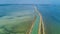 Aerial view of canal in lagoon of Mediterranean sea Etang de Thau water from above, France